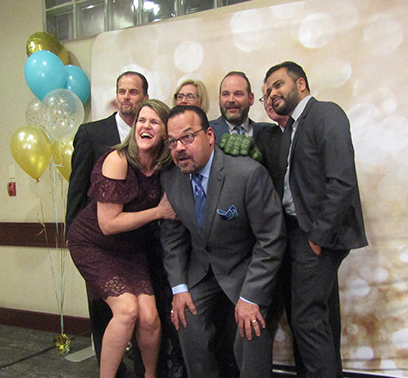 The Computrition New-Name Sales is having a fun time taking pictures in front of a photo booth for the 40th anniversary.